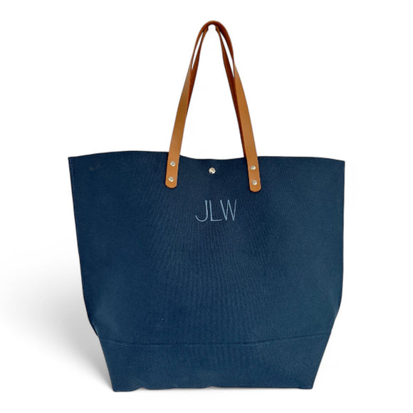 Blue canvas tote bag with leather shoulder straps