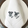 White 100% linen napkins with two detailed, embroidered dog's faces on, with their name to the side of the face