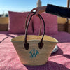 Shoulder Basket Handmade in northern Morocco from palm leaves from the doum plant. It is unlined and the leather handles are padded. Monogrammed with a traditional intertwined font.