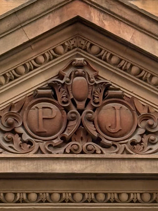 Architectural monogram for Peter Jones above the entrance to the shop on Symons Street
