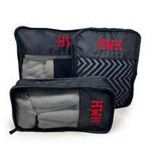 A set of Three packing cubes monogrammed with a modern font in red thread