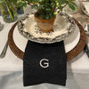 Black linen hemstitch napkin monogrammed with the letter G
