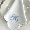 White Scallop Napkin monogrammed with a large traditional monogram in blue.