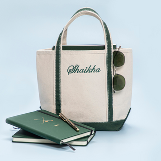 Boat tote bag with monogram embroidery on a light blue background