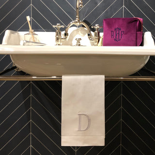 White linen guest towel with an embroidered monogram