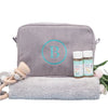 Grey 100% cotton corduroy with water-resistant lining Wash Bag with a large single letter monogram, on top of a grey towel 