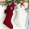 White and red Cable Knit Stockings both with single letter embroidered monograms