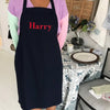100% organic cotton apron, with no pockets. Large embroidered name on the front