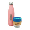 Glass keep cup, with a Multi-blue coloured lid, with a cork holder. The cork holder has an etched monogram. Behind is a pink water bottle with an etched monogram