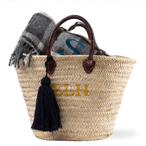 Hand Basket made from Palm leaves with leather handles. Has a three letter monogram embroidered on the front