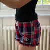 Red Gingham Flannel Shorts with Frilly Hem, made from 100% cotton flannel twill weave. Worn on a women model with a three letter monogram