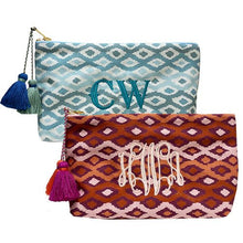 Ikat Wash Bags in the blues and reds colour. Both have a large centred monogram and tassels