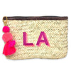 A clutch made from Hand woven from Palm Leaf in Morocco and and features a leather trim and an inside pocket. Monogramed with a Two large shadow font letters