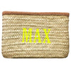 A clutch made from Hand woven from Palm Leaf in Morocco and and features a leather trim and an inside pocket. Monogramed with a bright thread
