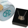 18k gold plated sterling silver Intertwined Monogram Necklace next to mini bond jewellery case 