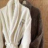 100% cotton white and taupe robes, with a single letter monogram, sewn on the left hand side.