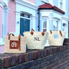 Three of Initially London's baskets along a wall. Each with a different monogram. 