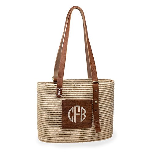 Monogrammed Rattan Bag made from Made from natural raffia, wound around a wire structure, with adjustable leather handles and patch - Initially London