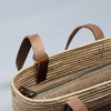 Richmond Rattan Bag made from Made from natural raffia, wound around a wire structure, with adjustable leather handles and accessories - Initially London