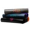 A collection of monogrammed Om Yoga Mats, made from phthalate-free PVC with no toxins. Each has a large monogram in various colours - Initially London