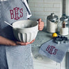 Monogrammed Navy Preppy Stripe Apron with Red Lettering, made from 50% linen and 50% cotton - Initially London