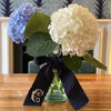 Dark Pitch Navy Wide Grosgrain Ribbon with Monogramming made from 100% Rayon Petersham which is tied a vase with flowers  - Initially London